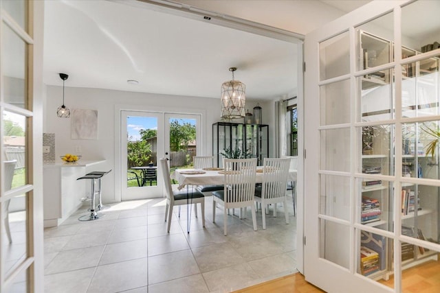 6003 Merriwood Dr, Austin, TX 78745 - dining area with french doors, a chandelier, and light tile patterned floors