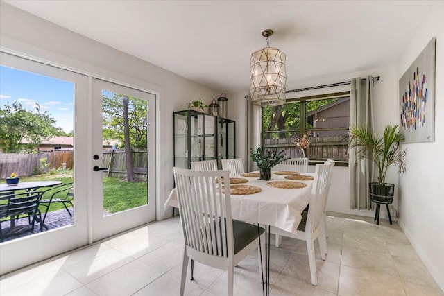 6003 Merriwood Dr, Austin, TX 78745 - dining room with plenty of natural light, french doors, a chandelier, and light tile patterned floors