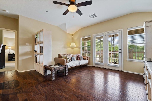 living room with hardwood / wood-style floors, ceiling fan, baseboards, lofted ceiling, and visible vents