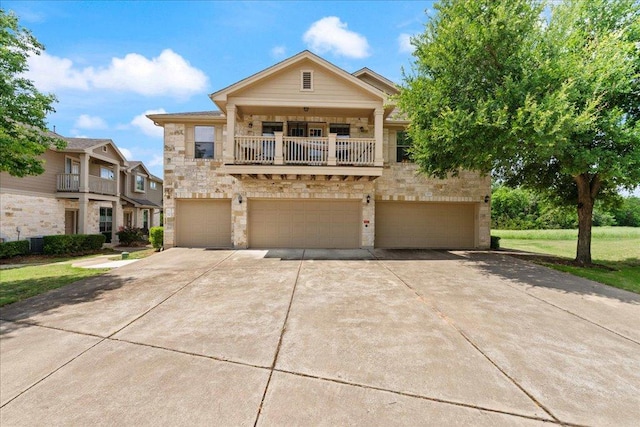 view of front of home with a balcony, concrete driveway, a front lawn, stone siding, and a garage
