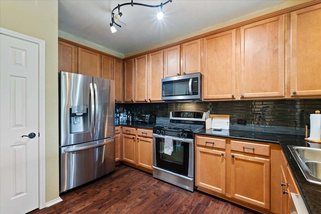 kitchen featuring stainless steel appliances, brown cabinetry, backsplash, and dark wood-style flooring