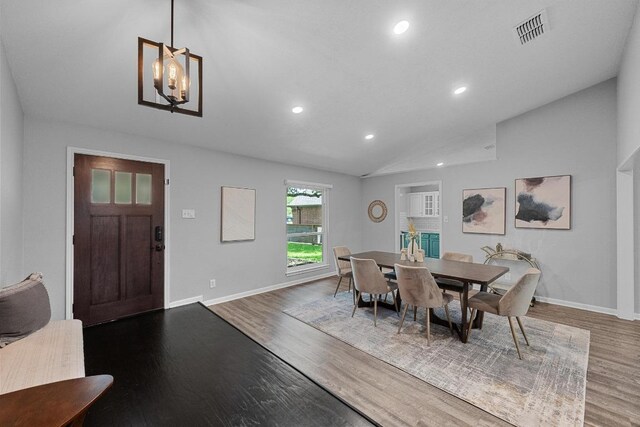 dining area featuring recessed lighting, lofted ceiling, wood finished floors, visible vents, and baseboards