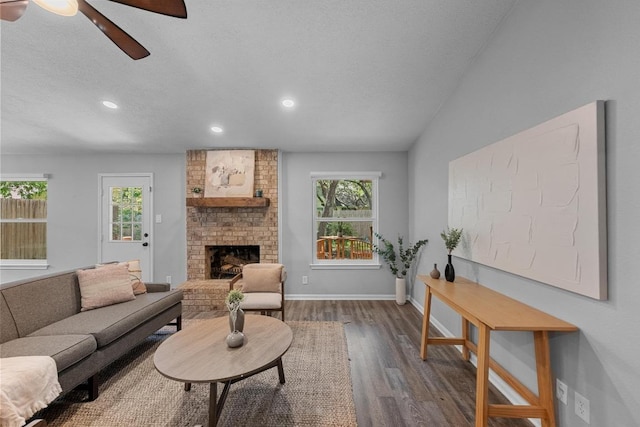 living room with a wealth of natural light, a ceiling fan, wood finished floors, and recessed lighting