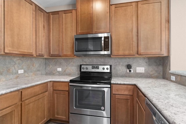 kitchen featuring brown cabinets, backsplash, and appliances with stainless steel finishes