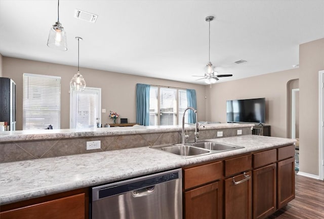 kitchen featuring dark wood finished floors, dishwasher, visible vents, a sink, and open floor plan