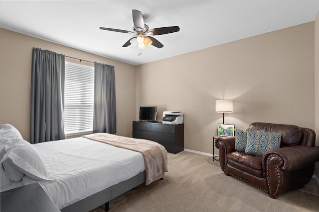 bedroom featuring ceiling fan, baseboards, and light carpet