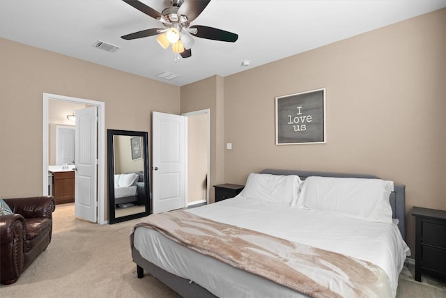 bedroom with a sink, visible vents, light colored carpet, ceiling fan, and connected bathroom