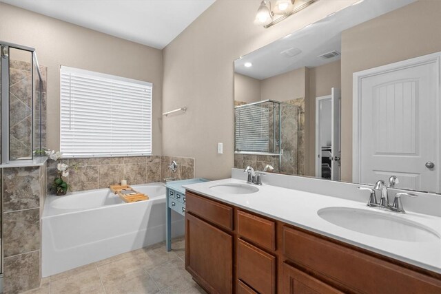 full bath featuring a bath, a sink, a shower stall, and double vanity