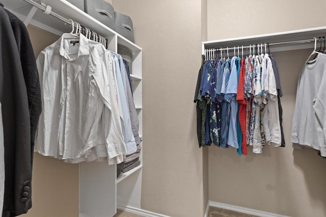walk in closet featuring carpet