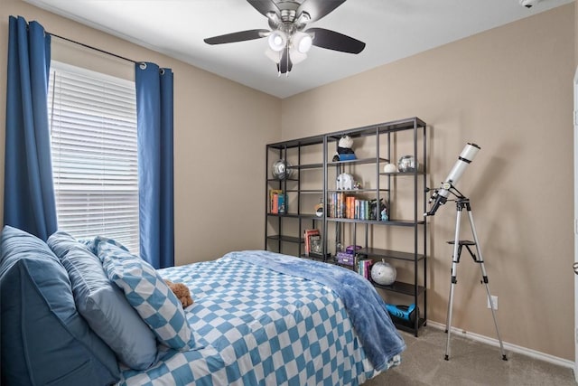 carpeted bedroom with a ceiling fan and baseboards