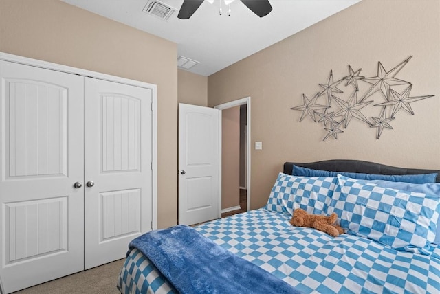 carpeted bedroom with a ceiling fan, visible vents, and a closet