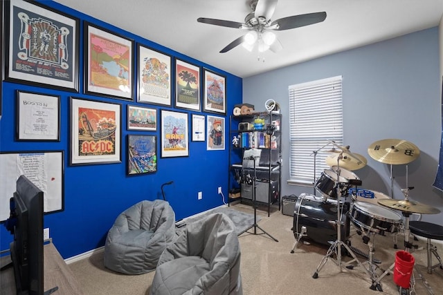 playroom with ceiling fan, baseboards, and carpet