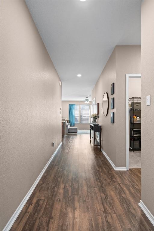 hall with wood finished floors and baseboards