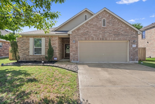 ranch-style house featuring an attached garage, a front lawn, brick siding, and concrete driveway
