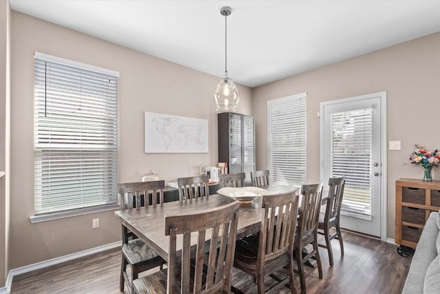 dining room featuring wood finished floors and baseboards