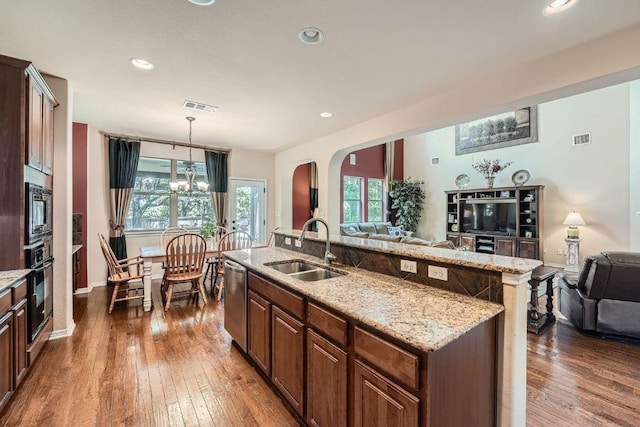 kitchen with open floor plan, stainless steel appliances, a sink, and visible vents