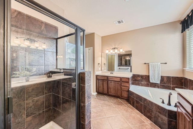 full bath with a stall shower, visible vents, tile patterned flooring, a garden tub, and vanity