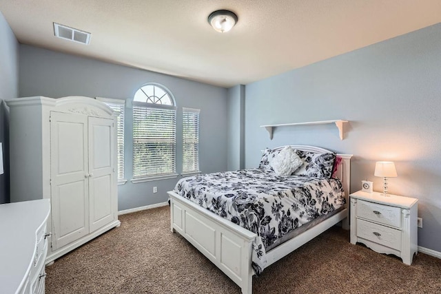 bedroom with baseboards, visible vents, and carpet floors