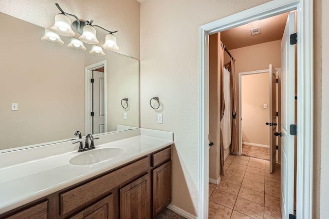 bathroom with tile patterned flooring, visible vents, vanity, baseboards, and a shower with shower curtain