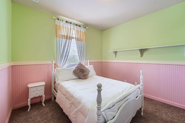 bedroom featuring carpet floors and a wainscoted wall