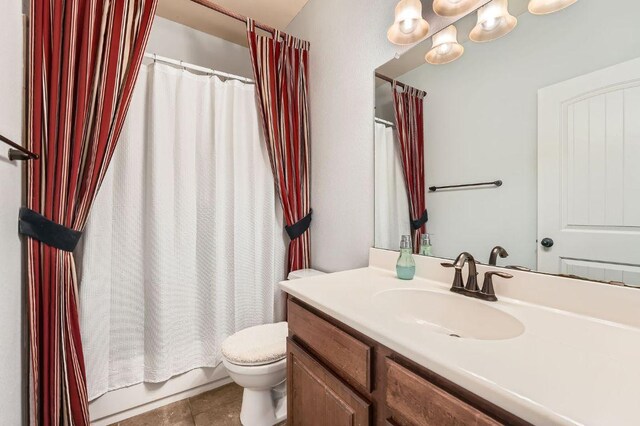 bathroom with tile patterned flooring, toilet, and vanity