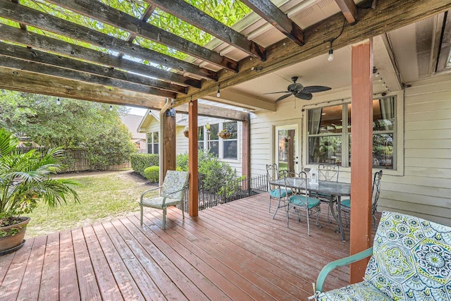 deck with a pergola, a lawn, outdoor dining area, fence, and ceiling fan