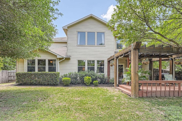 rear view of property featuring fence, a pergola, a yard, and a deck