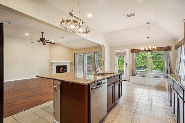kitchen featuring a sink, visible vents, lofted ceiling, and dishwasher