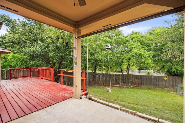 deck featuring a fenced backyard, a patio, and a yard