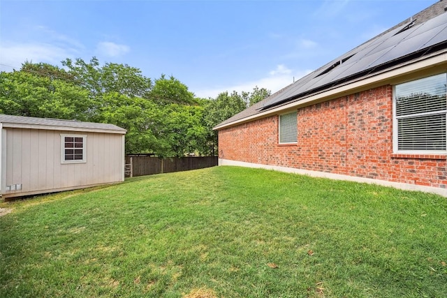 view of yard with fence and an outbuilding