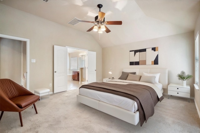 bedroom with a ceiling fan, light colored carpet, baseboards, lofted ceiling, and ensuite bath