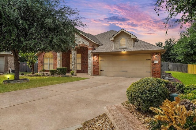 view of front of property with fence, a front yard, driveway, and brick siding