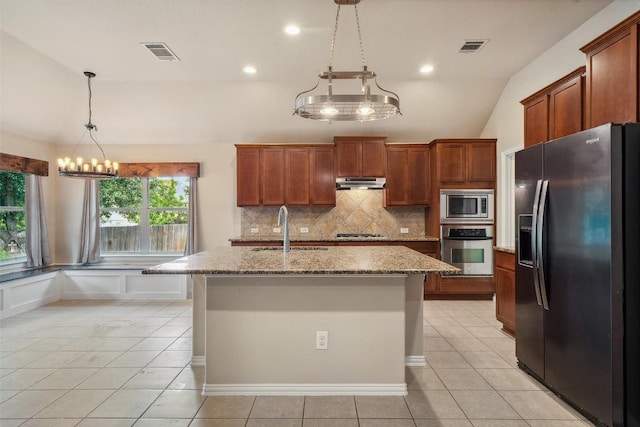1124 Dyer Creek Pl, Round Rock, TX 78665 - kitchen featuring stainless steel appliances, a sink, under cabinet range hood, tasteful backsplash, and light stone countertops
