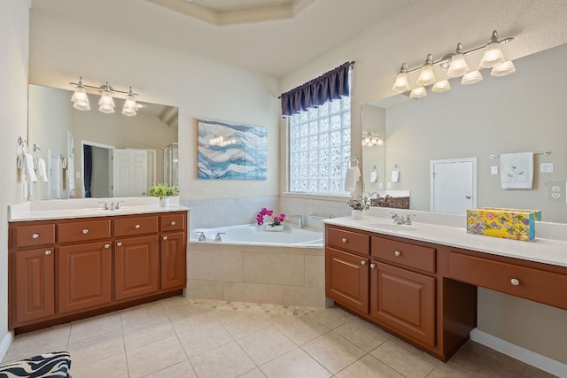 full bathroom featuring tile patterned floors, a bath, two vanities, and a stall shower