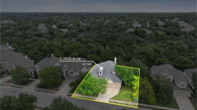 aerial perspective of suburban area with a forest and property boundaries highlighted
