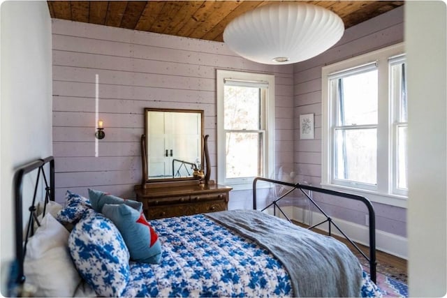 712 Harris Ave Unit 1, Austin, TX 78705 - bedroom featuring multiple windows, wood walls, wooden ceiling, and wood finished floors