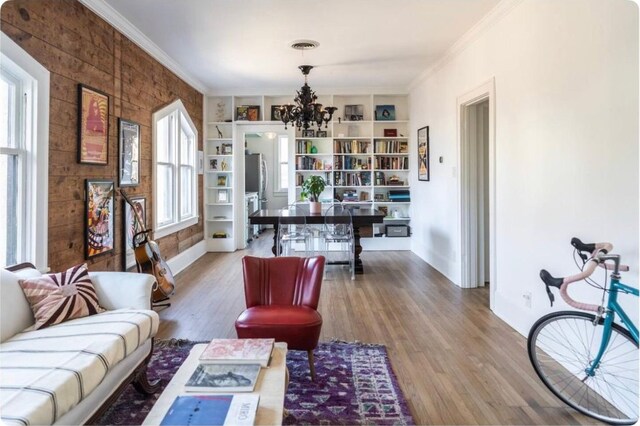 712 Harris Ave Unit 1, Austin, TX 78705 - living area with a chandelier, wood finished floors, crown molding, and built in shelves