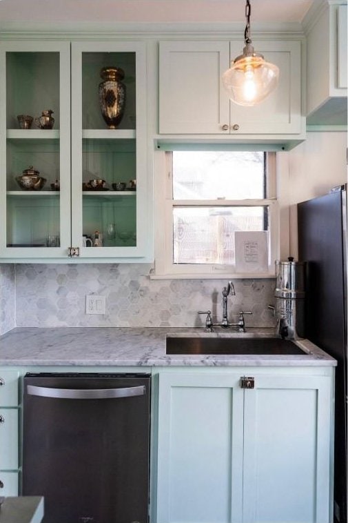 712 Harris Ave Unit 1, Austin, TX 78705 - kitchen featuring stainless steel dishwasher, white cabinetry, pendant lighting, glass insert cabinets, and tasteful backsplash