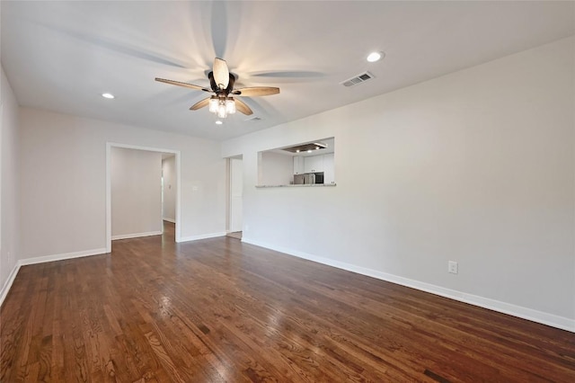 7611 Oak Hedge Pl, Austin, TX 78745 - unfurnished room with a ceiling fan, baseboards, dark wood-style flooring, and recessed lighting