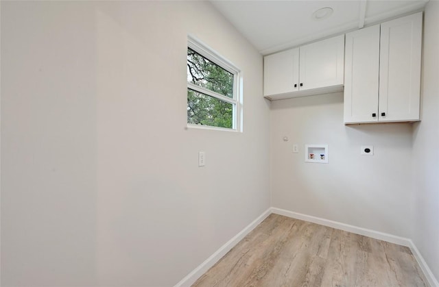7611 Oak Hedge Pl, Austin, TX 78745 - washroom featuring cabinet space, hookup for an electric dryer, light wood-style flooring, and baseboards