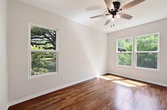 7611 Oak Hedge Pl, Austin, TX 78745 - unfurnished room with baseboards, wood finished floors, and a ceiling fan