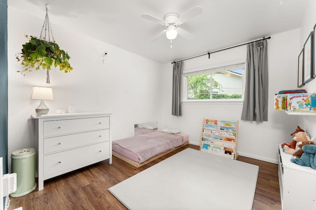 bedroom with baseboards and dark wood-style floors