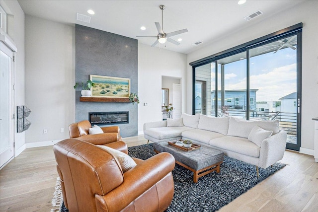 6229 Florencia Ln, Austin, TX 78724 - living area featuring light wood-style flooring, ceiling fan, recessed lighting, and a large fireplace