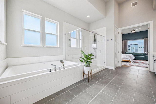 6229 Florencia Ln, Austin, TX 78724 - ensuite bathroom with a garden tub, a shower stall, tile patterned floors, and a ceiling fan