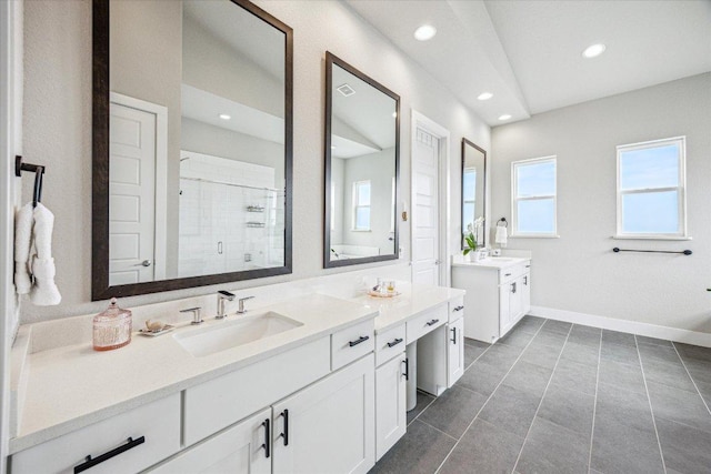 6229 Florencia Ln, Austin, TX 78724 - bathroom with a stall shower, two vanities, recessed lighting, and tile patterned floors