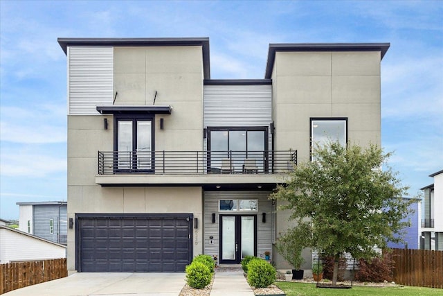6229 Florencia Ln, Austin, TX 78724 - contemporary house featuring a balcony, an attached garage, french doors, and concrete driveway