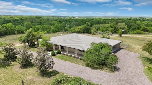 bird's eye view with a wooded view