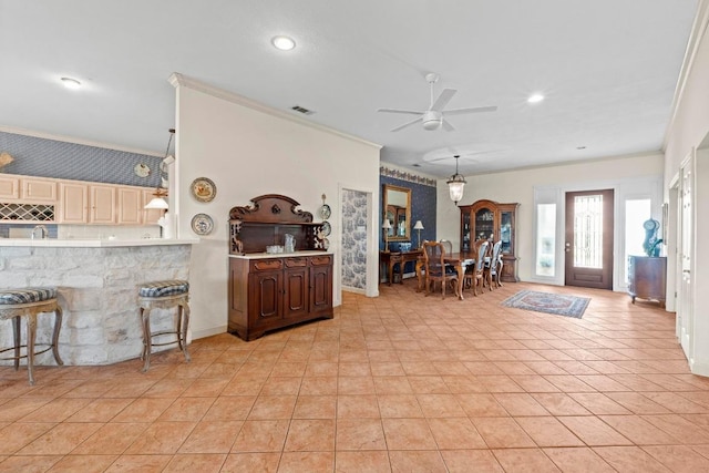 entrance foyer featuring ornamental molding, a ceiling fan, recessed lighting, and visible vents