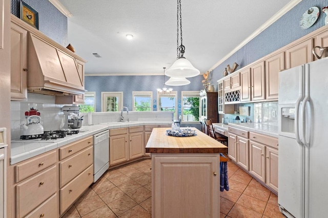 kitchen featuring white appliances, wallpapered walls, butcher block countertops, and plenty of natural light
