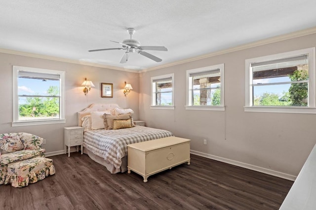 bedroom featuring crown molding, a ceiling fan, dark wood finished floors, and baseboards